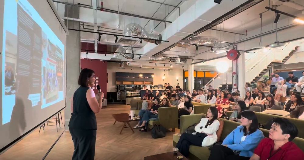 Claudia speaking to a crowd at an event