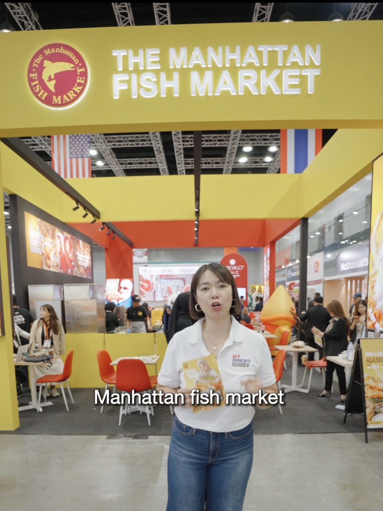 Claudia Ng presenting a franchise opportunity segment at The Manhattan Fish Market exhibition booth