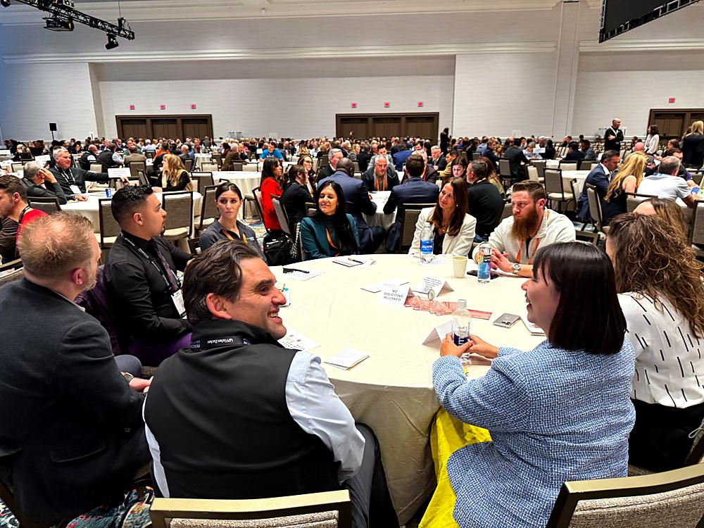A full ballroom of roundtables at a US franchise conference